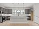 Spacious kitchen with gray cabinetry, a large island, and modern appliances at 436 Nathaniel Way # Brx0042, Charlotte, NC 28213