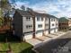 Back of townhome featuring a two-car garage, driveway, and neatly landscaped yard space at 436 Nathaniel Way # Brx0042, Charlotte, NC 28213
