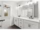 Bright bathroom features double vanity, sleek fixtures, and modern design with a bedroom entrance in the background at 440 Nathaniel Way # Brx0041, Charlotte, NC 28213