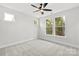 Bright bedroom with neutral carpeting, a ceiling fan, and multiple windows providing natural light at 440 Nathaniel Way # Brx0041, Charlotte, NC 28213