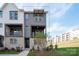 Charming townhome boasts a modern gray exterior with brick accents and a cozy second-story balcony at 440 Nathaniel Way # Brx0041, Charlotte, NC 28213
