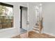 Hallway leading to outdoor porch with gray wooden slats and interior stairs at 440 Nathaniel Way # Brx0041, Charlotte, NC 28213