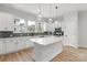 Bright kitchen featuring an island, white cabinets, and modern backsplash at 440 Nathaniel Way # Brx0041, Charlotte, NC 28213
