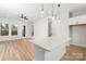 Bright living room with wood floors, a ceiling fan, and an eat-in kitchen area with a quartz countertop at 440 Nathaniel Way # Brx0041, Charlotte, NC 28213