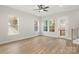 Bright living room featuring wood floors, a ceiling fan, and multiple windows providing natural light at 440 Nathaniel Way # Brx0041, Charlotte, NC 28213