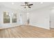 Bright living room featuring wood floors, a ceiling fan, and a doorway to the outside at 440 Nathaniel Way # Brx0041, Charlotte, NC 28213