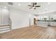 Spacious living room featuring wood floors, a ceiling fan and an eat-in kitchen area with modern appliances at 440 Nathaniel Way # Brx0041, Charlotte, NC 28213
