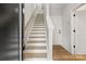 Bright staircase with wood treads and white risers, leading to the upper levels of the home at 440 Nathaniel Way # Brx0041, Charlotte, NC 28213