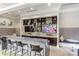 Upscale bar area with sleek countertops, stylish seating, and a built-in display for a modern feel at 4436 Moxie Way, Charlotte, NC 28215