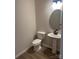 Small bathroom with pedestal sink and oval mirror at 608 Lispenard Ct, Mount Holly, NC 28120