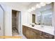 Double vanity bathroom with a large mirror and shower at 608 Lispenard Ct, Mount Holly, NC 28120