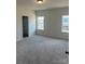 Bright bedroom with carpet flooring and ample natural light at 608 Lispenard Ct, Mount Holly, NC 28120