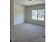 Spacious bedroom with carpet and large window at 608 Lispenard Ct, Mount Holly, NC 28120