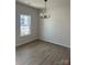 Simple dining room with hardwood floors and chandelier at 608 Lispenard Ct, Mount Holly, NC 28120