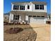 Two-story house with white siding, stone accents, and a two-car garage at 608 Lispenard Ct, Mount Holly, NC 28120