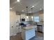 Modern kitchen with island, stainless steel appliances, and white cabinetry at 608 Lispenard Ct, Mount Holly, NC 28120