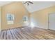 Spacious bedroom featuring vaulted ceilings, two windows, and wood-look floors, offering a comfortable and inviting space at 751 White Jenkins Rd, Bessemer City, NC 28016