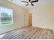 This bedroom boasts natural light, hardwood floors, a ceiling fan and neutral paint, creating a calming atmosphere at 751 White Jenkins Rd, Bessemer City, NC 28016