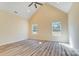 Bright bedroom with vaulted ceilings, natural light from two windows, and modern wood-look flooring at 751 White Jenkins Rd, Bessemer City, NC 28016