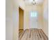 Bright foyer with wood-look flooring leading to a white door with glass panes at 751 White Jenkins Rd, Bessemer City, NC 28016