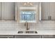 Kitchen window view overlooking a leafy backyard with white subway tile backsplash and stainless steel sink at 751 White Jenkins Rd, Bessemer City, NC 28016