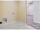 Functional laundry area with utility connections, tiled flooring, and access to additional rooms, designed for convenience at 751 White Jenkins Rd, Bessemer City, NC 28016