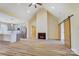 Open-concept living room and kitchen featuring stainless steel appliances and a cozy fireplace at 751 White Jenkins Rd, Bessemer City, NC 28016