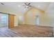 Spacious living room featuring vaulted ceilings, modern ceiling fan and wood-look floors at 751 White Jenkins Rd, Bessemer City, NC 28016