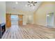 Bright and airy living room featuring wood-look floors, a ceiling fan and a fireplace at 751 White Jenkins Rd, Bessemer City, NC 28016