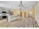 Open concept kitchen and living area featuring stainless appliances, a large island, and modern gray cabinetry at 751 White Jenkins Rd, Bessemer City, NC 28016
