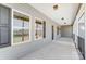 Spacious covered porch featuring paneled siding, ceiling lights, and black railing at 751 White Jenkins Rd, Bessemer City, NC 28016