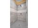 A close-up of the tiled shower space showcasing the rainfall shower head, faucet hardware and mosaic tile floor at 751 White Jenkins Rd, Bessemer City, NC 28016