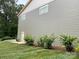 Side of home with manicured mulch garden and modern siding at 139 Poplar Grove Rd, Mooresville, NC 28117