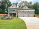 Two-story home with a three car garage, stone accents, and manicured lawn at 139 Poplar Grove Rd, Mooresville, NC 28117