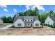 White farmhouse with gray roof, landscaping, and driveway; aerial view at 2610 Henry Baucom Rd, Monroe, NC 28110