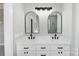 Double vanity bathroom with arched mirrors and modern fixtures at 2610 Henry Baucom Rd, Monroe, NC 28110