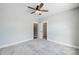 Grey bedroom with carpet, ceiling fan and doors to closet and bathroom at 2610 Henry Baucom Rd, Monroe, NC 28110