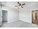 Bright bedroom with ceiling fan and access to closet and hallway at 2610 Henry Baucom Rd, Monroe, NC 28110