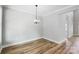 Bright dining room with hardwood floors and a modern light fixture at 2610 Henry Baucom Rd, Monroe, NC 28110