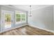 Bright dining room with hardwood floors, large window, and chandelier at 2610 Henry Baucom Rd, Monroe, NC 28110