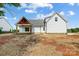 White house exterior with a covered patio and landscaping at 2610 Henry Baucom Rd, Monroe, NC 28110