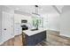 Modern kitchen with white cabinets, island, quartz countertops, and pendant lighting at 2610 Henry Baucom Rd, Monroe, NC 28110