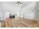 Open concept living room with kitchen, island, hardwood floors and high ceilings at 2610 Henry Baucom Rd, Monroe, NC 28110