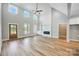 Spacious living room with high ceilings, hardwood floors, fireplace, and built-in shelving at 2610 Henry Baucom Rd, Monroe, NC 28110