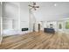 Open living space with high ceilings, hardwood floors, kitchen island, and fireplace at 2610 Henry Baucom Rd, Monroe, NC 28110