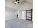 Main bedroom with barn door entry to en-suite bathroom at 2610 Henry Baucom Rd, Monroe, NC 28110