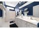 Elegant bathroom with double vanity, bathtub, and navy blue walls at 7457 Waterleaf Ct, Stanley, NC 28164