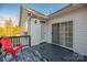 Back deck with red chair and sliding glass door at 7457 Waterleaf Ct, Stanley, NC 28164