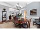 Formal dining room, hardwood floors, and a view into the living room at 7457 Waterleaf Ct, Stanley, NC 28164