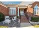 Inviting front porch with rocking chairs and brick steps at 7457 Waterleaf Ct, Stanley, NC 28164